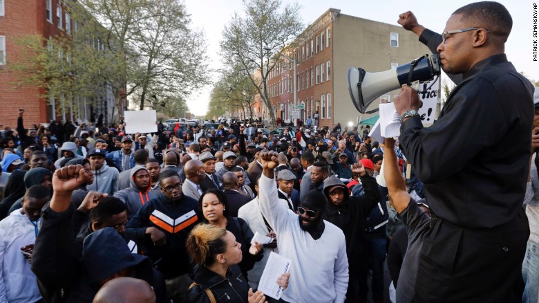 Malik Z. Shabazz, of Black Lawyers for Justice, speaks to a group of protesters outside the Western District police station.
