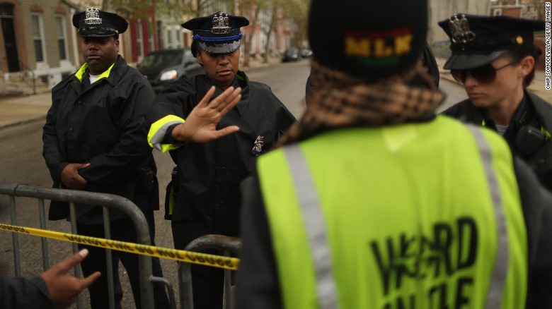 Baltimore Police keep demonstrators back outside the Western District station.