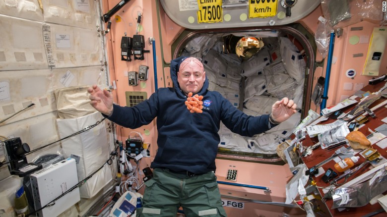 NASA astronaut Scott Kelly watches fresh carrots float in front of him on the International Space Station on Sunday, April 19. Scott is taking part in a one-year mission to test how the human body reacts to an extended time in space.