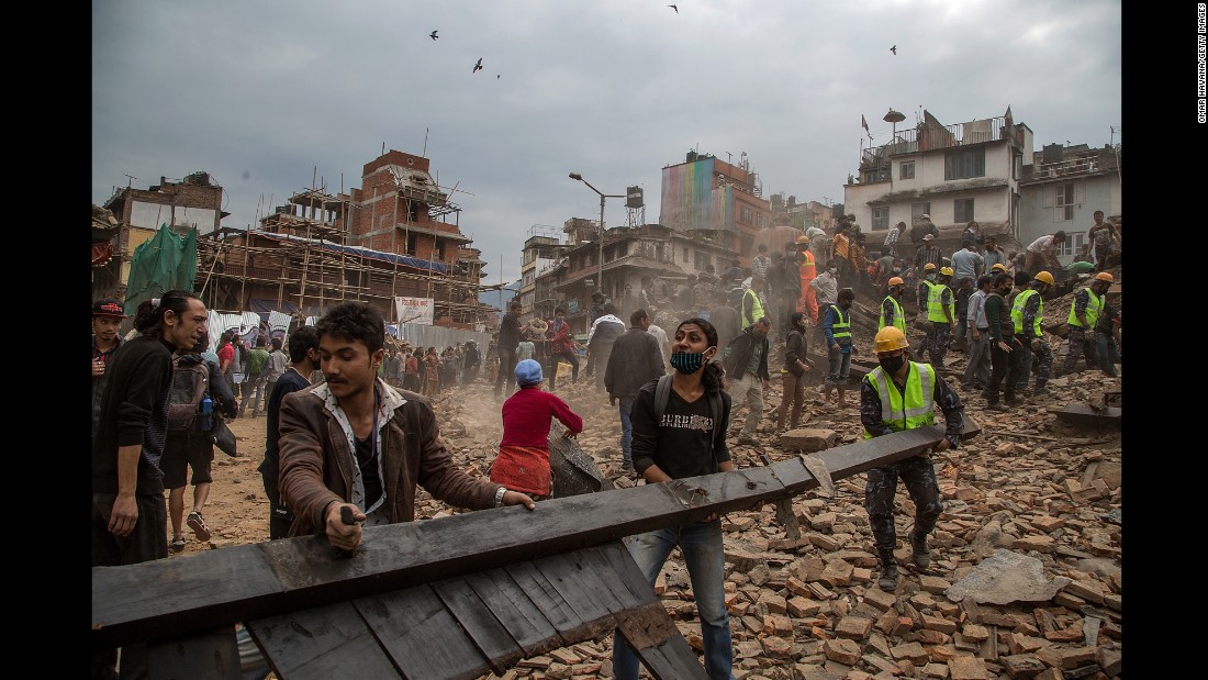 Rescue workers clear debris in Kathmandu while searching for survivors.