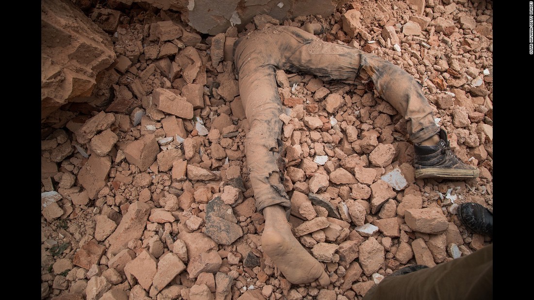 A victim of Nepal&#39;s earthquake lies in the debris of Dharahara after it collapsed on April 25 in Kathmandu, Nepal. 