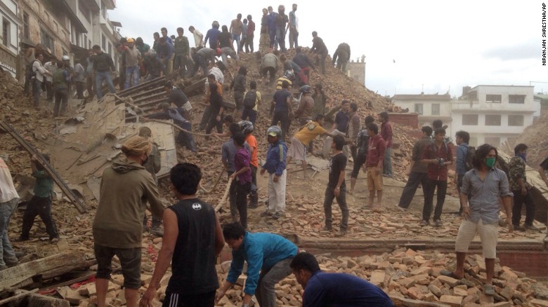 Volunteers help with rescue work at the site of a building that collapsed in Kathmandu.