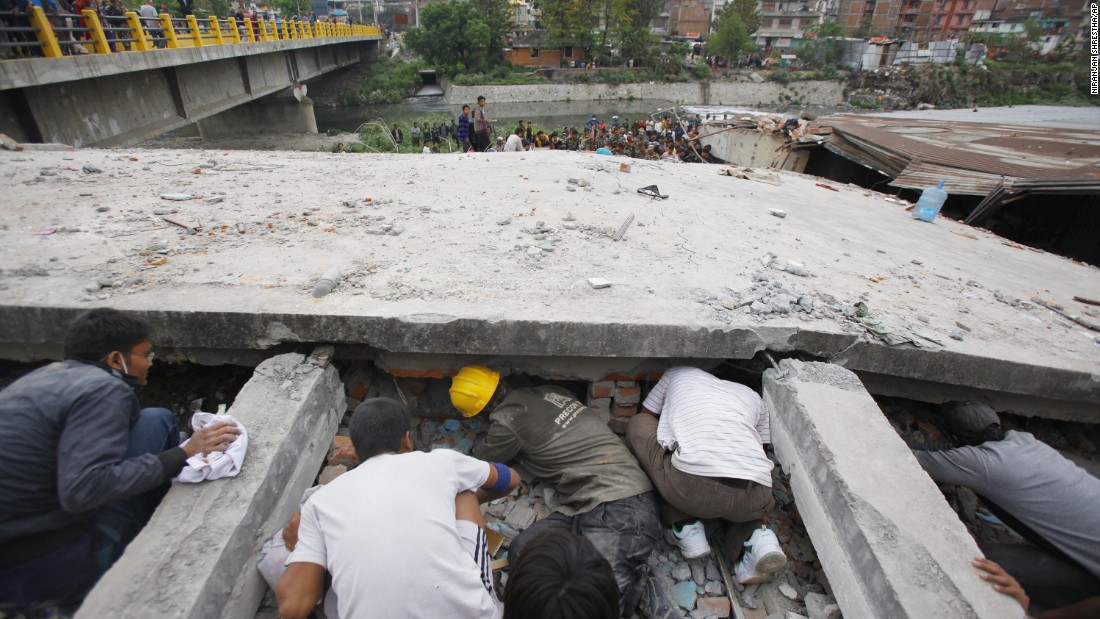 Rescuers look for victims under a collapsed building in Kathmandu on April 25. 