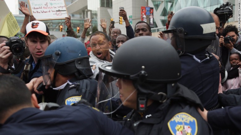 Protesters get into a shoving match with police during a march downtown on April 25.