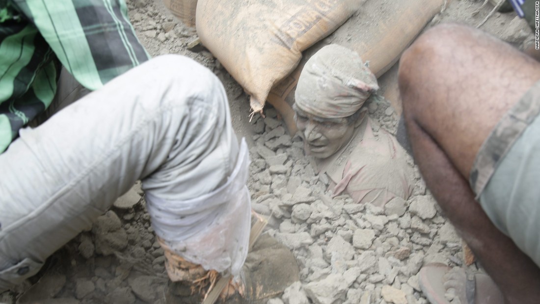 People try to free a man from the rubble in Kathmandu, Nepal, on April 25. Cheers rose from the piles when people were found alive -- but mostly bodies turned up. 