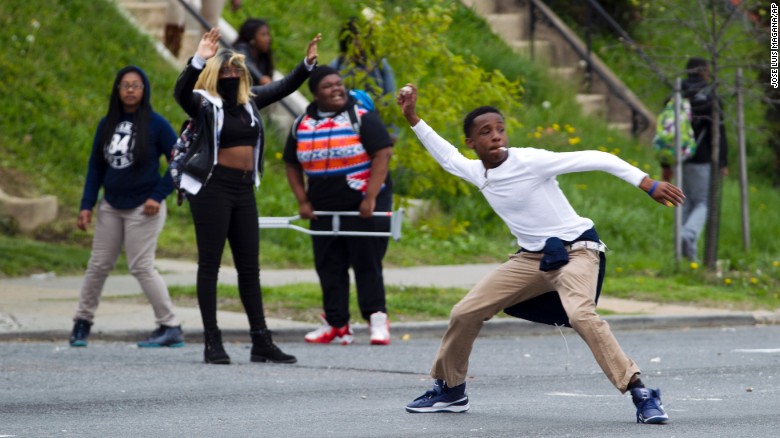 Demonstrators throw rocks at the police after Gray's funeral on April 27.