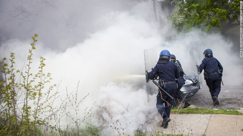 Police react during the riot on April 27.