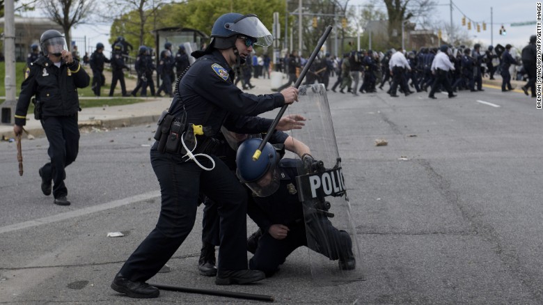 Police officers clash with protesters in the streets near Mondawmin Mall on April 27.