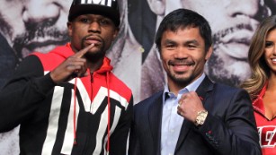 WBC/WBA welterweight champion Floyd Mayweather Jr. (L) and WBO welterweight champion Manny Pacquiao pose during a news conference at the KA Theatre at MGM Grand Hotel &amp; Casino on April 29, 2015 in Las Vegas, Nevada. The two will face each other in a unification bout on May 2, 2015 in Las Vegas. AFP PHOTO / JOHN GURZINSKI (Photo credit should read JOHN GURZINSKI/AFP/Getty Images)