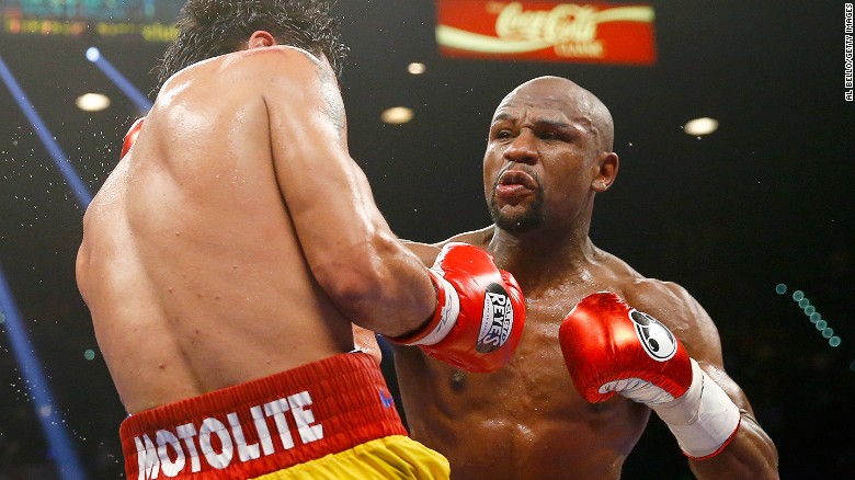 LAS VEGAS, NV - MAY 02: Floyd Mayweather Jr. throws a right at Manny Pacquiao during their welterweight unification championship bout on May 2, 2015 at MGM Grand Garden Arena in Las Vegas, Nevada. (Photo by Al Bello/Getty Images)