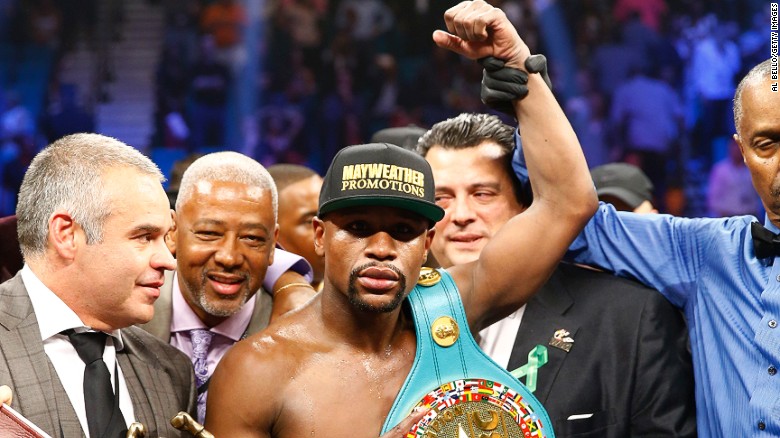 Floyd Mayweather Jr. celebrates victory after the MGM clash.