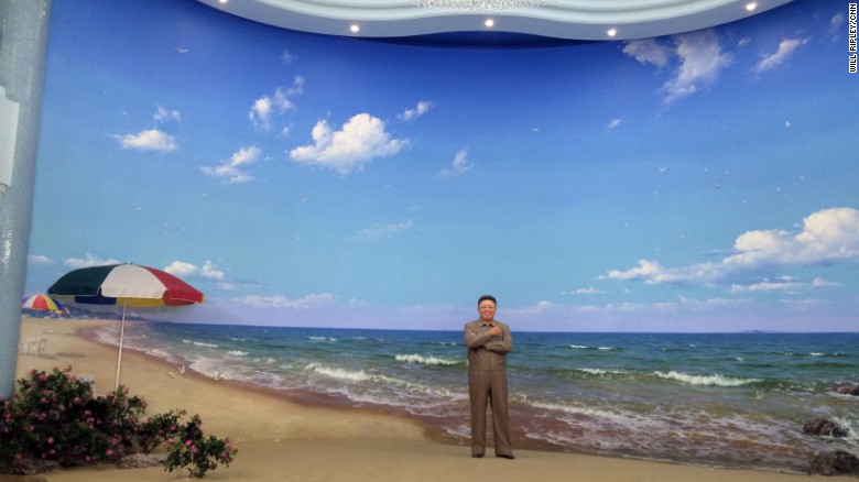 A life-size statue of late leader Kim Jong Il stands at the entrance to a new water park in Pyongyang. Visitors bow to pay their respects.