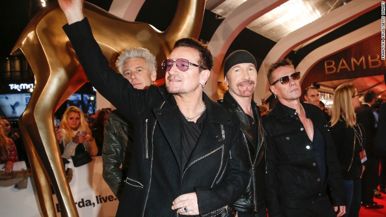 Bono waves as he and the rest of U2 -- Adam Clayton, The Edge and Larry Mullen Jr. -- arrive at an awards show in Berlin in November.
