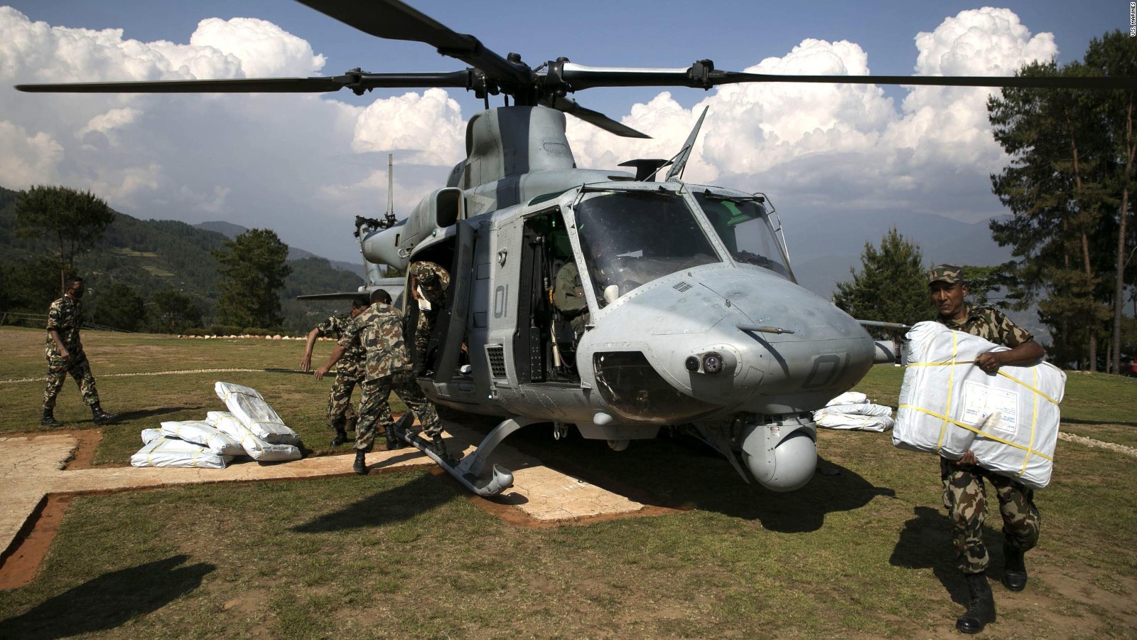 Nepalese military service members unload supplies from a UH-1Y Huey in Charikot, Nepal, May 5, Nepal, May 5.