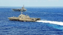 The littoral combat ship USS Independence (LCS 2) conducts maneuvers with the aircraft carrier USS Ronald Reagan (CVN 76) during Rim of the Pacific (RIMPAC) Exercise 2014.