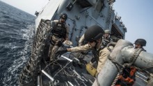 Chief Gunner's Mate Nicholas Bokan, assigned to Surface Warfare Mission Package, Detachment 1, embarked aboard the littoral combat ship USS Fort Worth (LCS 3), rigs a caving ladder on the flight deck during a visit, board, search, and seizure training drill. 