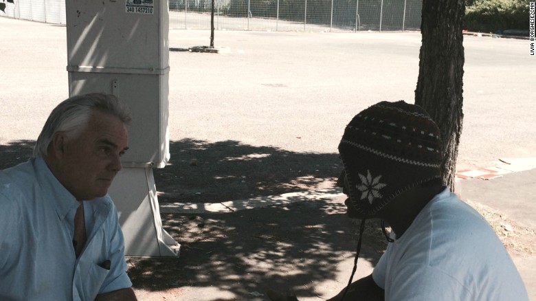 CNN International correspondent Ben Wedeman (L) with Benjamin, an Eritrean migrant in a park in Ponte Mammolo in northern Rome. He was one of a very few migrants in park who would agree to an interview. 