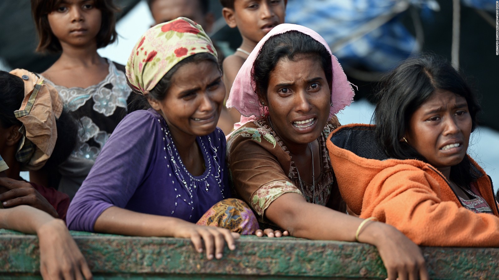 Rohingya migrant women cry as they sit on a boat drifting in Thai waters off the southern island of Koh Lipe in the Andaman sea on May 14, 2015. The boat crammed with scores of Rohingya migrants -- including many young children -- was found drifting in Thai waters on May 14, according to an AFP reporter at the scene, with passengers saying several people had died over the last few days.