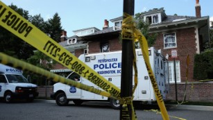 Caption:WASHINGTON, DC - MAY 19: District of Columbia Metropolitan Police maintain a perimeter around the house on the 3200 block of Woodland Drive NW May 19, 2015 in Washington, DC. Firefighters discovered the bodies of Savvas Savopoulos, 46, his wife Amy, 47, their 10-year-old son Philip, and the housekeeper, Veralicia Figueroa, 57, last Thursday afternoon when they responded to a blaze at the house. Two Savopoulos daughters were away in boarding school at the time. Investigators have ruled the deaths homicides and say they could continue to collect evidence at the house for another week. (Photo by Chip Somodevilla/Getty Images)
