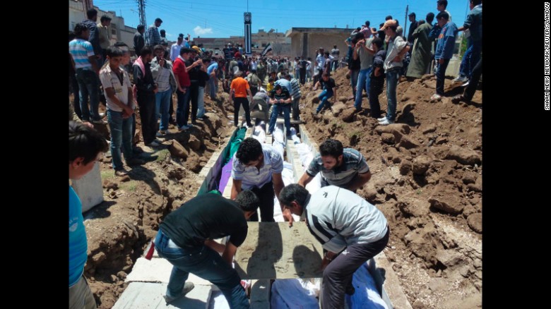 People gather on May 26, 2012, at a mass burial for victims reportedly killed by Syrian forces in Syria&#39;s Houla region. U.N. officials confirmed that &lt;a href=&quot;http://www.cnn.com/2012/05/27/world/meast/syria-unrest/index.html&quot; target=&quot;_blank&quot;&gt;more than 100 Syrian civilians were killed&lt;/a&gt;, including nearly 50 children. Syria&#39;s government denied its troops were behind the bloodbath.