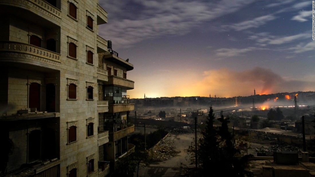 Smoke rises in the Hanano and Bustan al-Basha districts in Aleppo as fighting continues through the night on December 1, 2012.