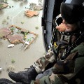 An Air Force Reserve pararescueman from the 920th Rescue Wing scans the ravaged Texas landscape in the aftermath of Hurricane Ike. 