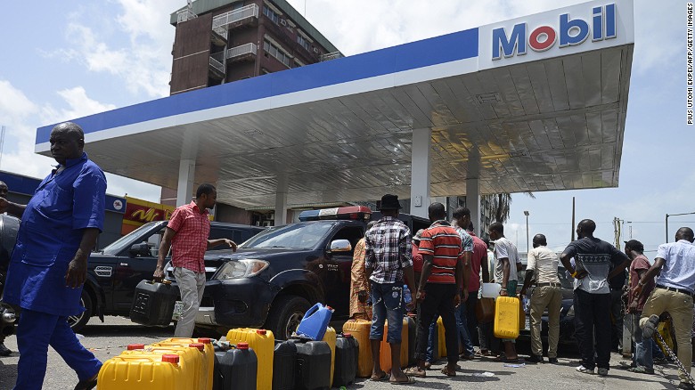 People line up to buy fuel last week at a Mobil gas station in Lagos, Nigeria.