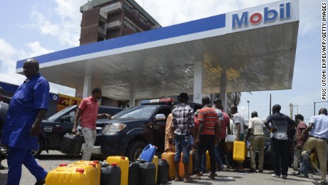 People line up to buy fuel last week at a Mobil gas station in Lagos, Nigeria.