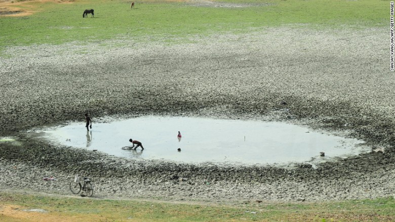 Fishermen attempt to catch fish in a shrunken pond in Phaphamau, India, on May 26. 