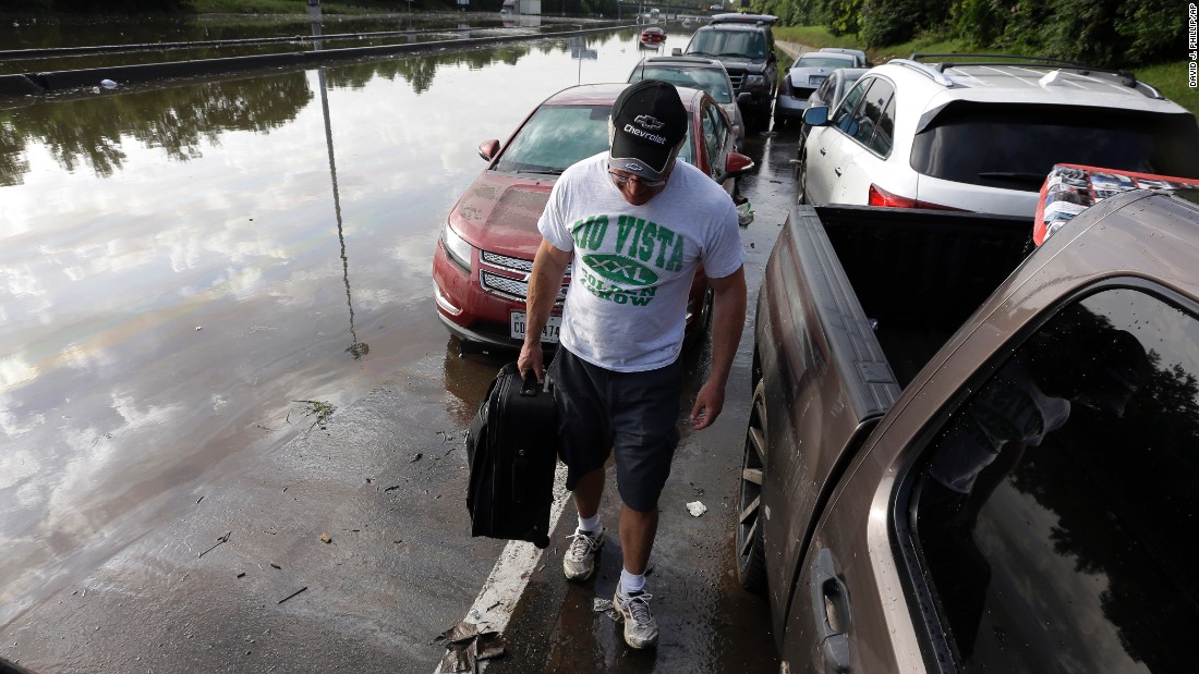 Robert Briscoe removes a suitcase from his flooded car along I-45 in Houston on May 26.