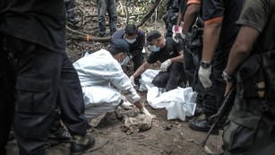 Forensic teams exhume graves found at trafficking camps