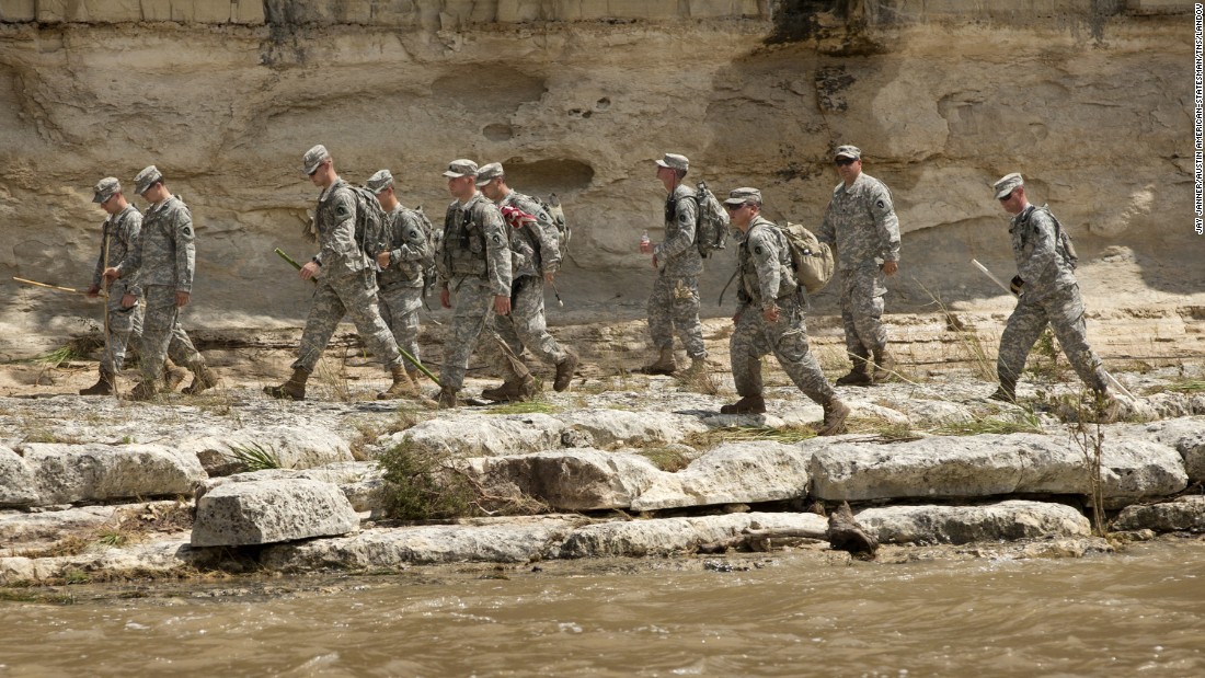 Members of the Texas National Guard search for bodies on the banks of the Blanco River after flooding in Wimberley, Texas, on May 26.