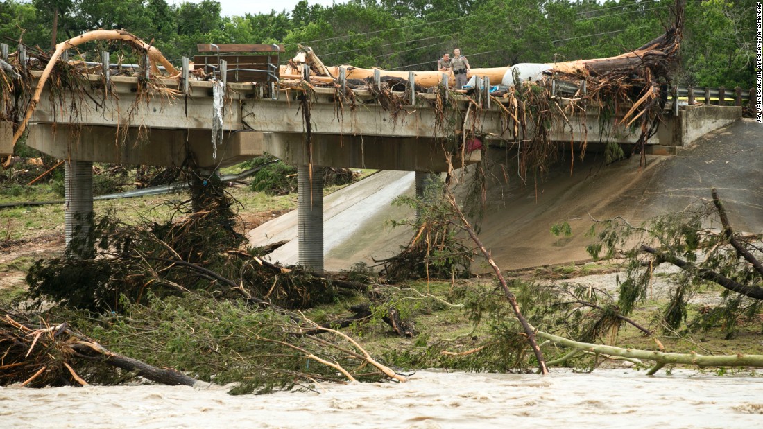 A large tree rests on the Highway 12 bridge over the Blanco River in Wimberley on May 24. 