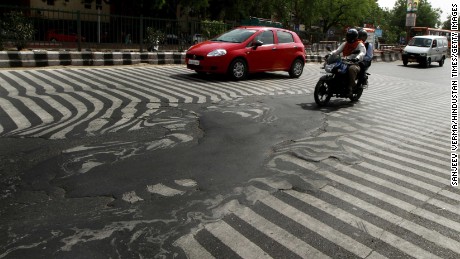 A road melts near Safdarjung Hospital in Delhi after temperatures rose to 45 C on May 24, 2015.