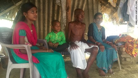 Mallayia Baddula sits with his family in the stiflying heat of their hut in Perepally, outside Hyderabad.