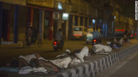 Men sleep on concrete road dividers during a heat wave in Delhi, May 27, 2015.