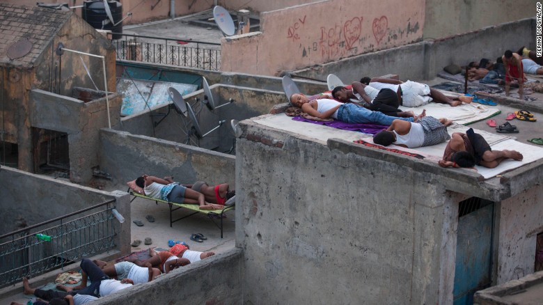 People sleep on roofs in New Delhi to escape the heat trapped in their concrete homes on Friday, May 29. A blistering heat wave has killed more than 1,300 people in the country.