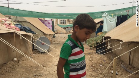 A boy stands between tents at a refugee camp in the al-Jamiaa neighborhood of Baghdad, Iraq, on Thursday, May 28. The camp houses people who have fled from ISIS-dominated Anbar province west of Baghdad.
