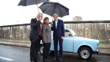 During a tour of the Berlin Wall memorial on October 22, 2014, in Berlin, Kerry and German Foreign Minister Frank-Walter Steinmeier, left, chat with Regina Webert-Lehmann, who in 1989 fled from communist East Germany in her Trabant car (pictured) to Hungary shortly before revolutions swept Eastern Europe. Kerry and Steinmeier met with students and walked along a still-standing portion of the wall that divided East and West Berlin and whose fall 25 years ago marked the end of the Cold War.