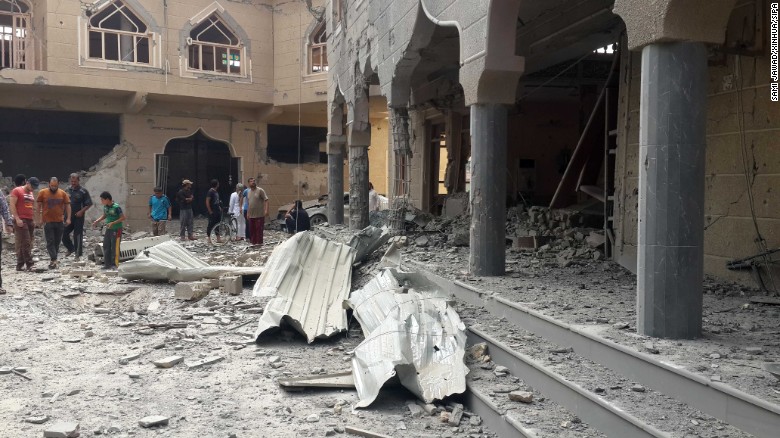 Residents examine a damaged mosque after an Iraqi Air Force bombing in the ISIS-seized city of Falluja, Iraq, on Sunday, May 31. At least six were killed and nine others wounded during the bombing.