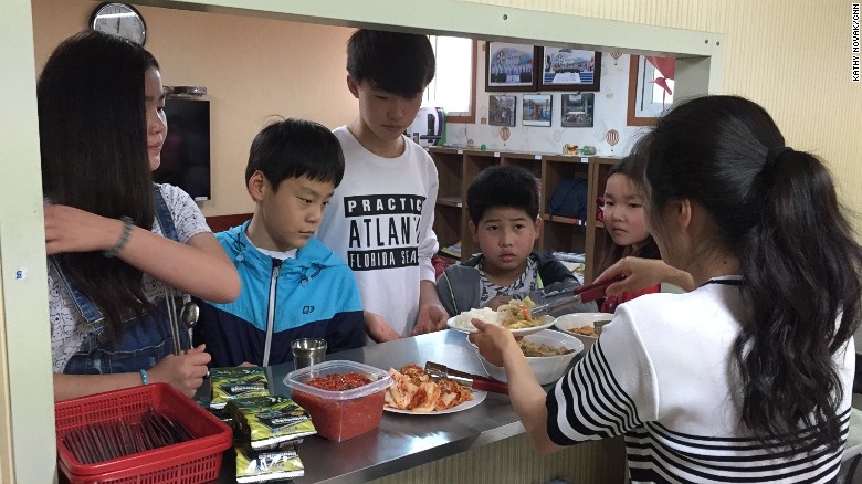 Children queue for lunch at the Kumgang school in Seoul.