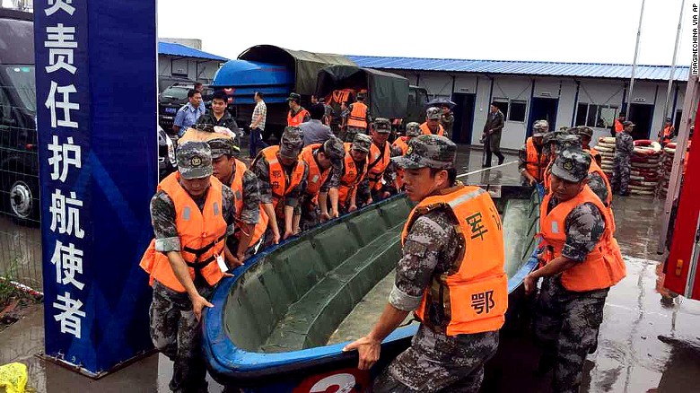 Chinese soldiers carry a boat to search for survivors on June 2.