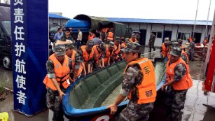 Chinese soldiers carry a boat to search for survivors on June 2.