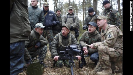 An American soldier, right, trains Ukrainian troops on Tuesday, April 21, near Yavoriv, Ukraine. Operation Fearless Guardian, a six-month training exercise, involves about 300 members of the American 173rd Airborne and about 900 Ukrainian National Guard troops.
