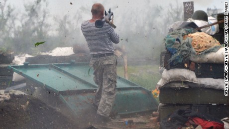 A Ukrainian serviceman fires a grenade launcher on the front lines near Donetsk on Saturday, May 30.