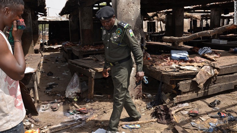 A Nigerian policeman inspects the site of a suicide attack at a busy cattle market in the northeastern Nigerian city of Maiduguri on June 2, 2015.