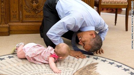 Obama bonds with baby in the Oval Office