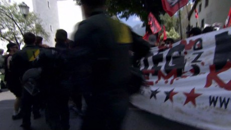 Riot police fire pepper spray at G7