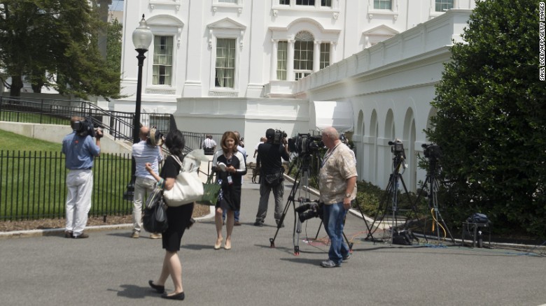 Members of the press evacuate from the Press Briefing Room at the White House following a bomb threat.