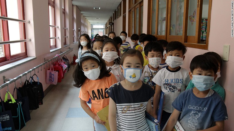 Elementary school students wear masks as a precaution against the MERS virus as they wait for a lesson to start at Midong Elementary School in Seoul, South Korea.